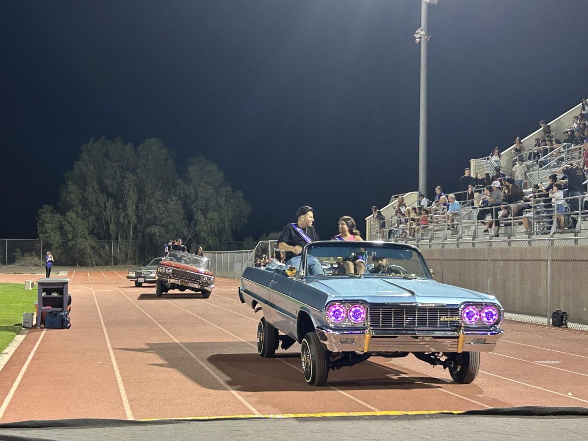 Lowriders, carrying members of the Homecoming court, lead the parade on Sept. 29, 2023.