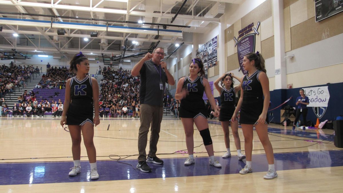 Coach Davis, Shadow's new Athletic Director, and members of the Cheer Team, lead the students in a cheer during the Welcome Back Rally on Aug. 30. 