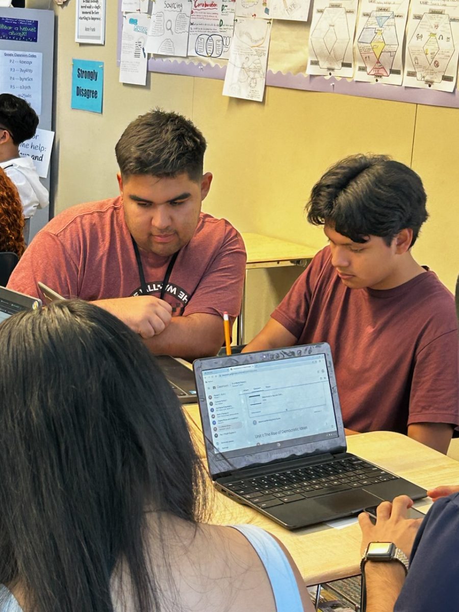 Mr. Gordillo works with students during class. 