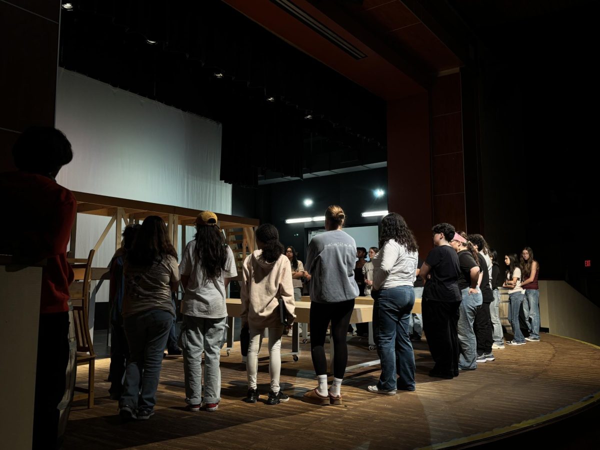 The cast of Triangle meeting on stage in the PAC on Oct. 13, 2025. 